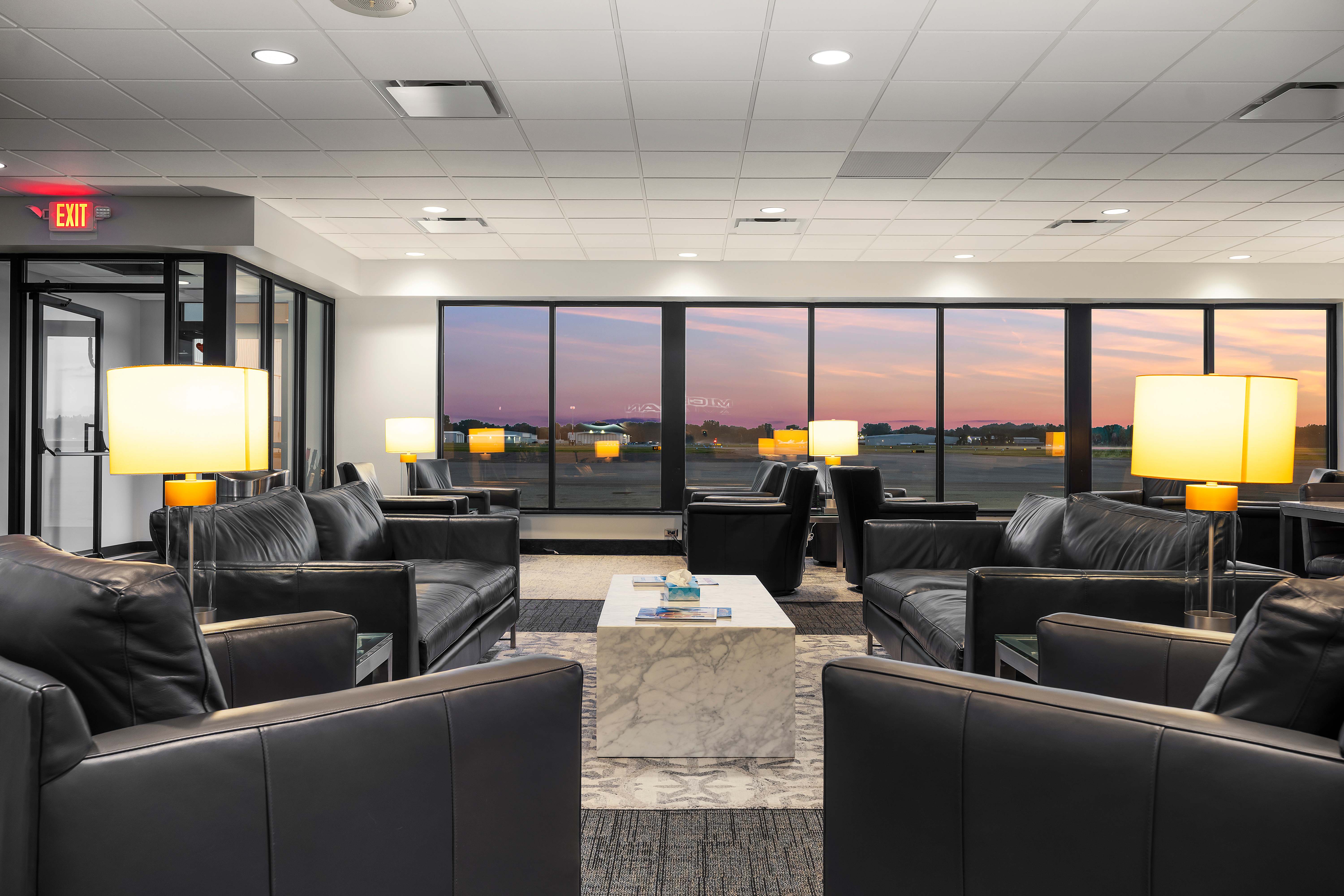Pilot lounge at Michigan Aviation FBO with ramp view at sunset